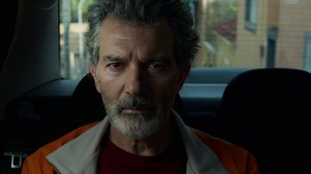 Movie still from “Pain and Glory” (2019), directed by Pedro Almodóvar – An older man with grey hair sitting in a car; Close Up shot, Low angle