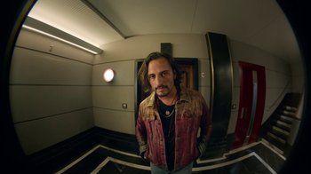 Movie still from “Pain and Glory” (2019), directed by Pedro Almodóvar – A man standing in a room with his hands in his pockets; Medium shot, Low angle