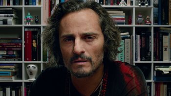 Movie still from “Pain and Glory” (2019), directed by Pedro Almodóvar – A person with long curly hair; Close Up shot, Low angle
