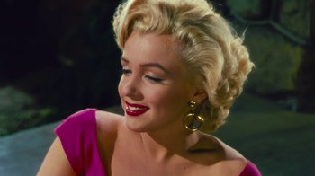 Movie still from “Pain and Glory” (2019), directed by Pedro Almodóvar – A person with blonde hair wearing a pink dress; Close Up shot, Over the shoulder angle