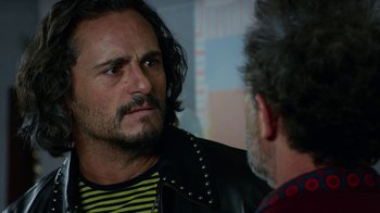 Movie still from “Pain and Glory” (2019), directed by Pedro Almodóvar – A man in a leather jacket talking to another man; Close Up shot, Over the shoulder angle