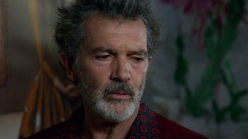 Movie still from “Pain and Glory” (2019), directed by Pedro Almodóvar – An older man with grey hair and a beard; Close Up shot, Over the shoulder angle
