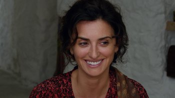 Movie still from “Pain and Glory” (2019), directed by Pedro Almodóvar – A person with a smile on their face; Close Up shot, Over the shoulder angle