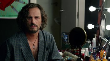 Movie still from “Pain and Glory” (2019), directed by Pedro Almodóvar – A person sitting in a room near a mirror; Close Up shot, Over the shoulder angle