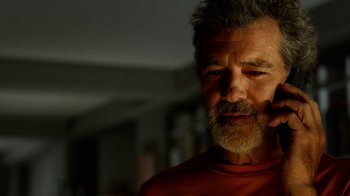 Movie still from “Pain and Glory” (2019), directed by Pedro Almodóvar – An older man with grey hair and a gray beard; Close Up shot, Low angle