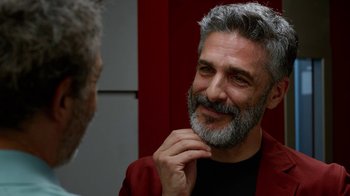 Movie still from “Pain and Glory” (2019), directed by Pedro Almodóvar – A man with a gray beard looking at himself in the mirror; Close Up shot, Over the shoulder angle