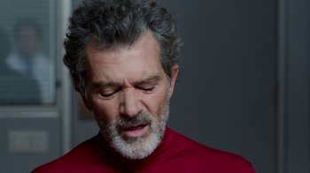 Movie still from “Pain and Glory” (2019), directed by Pedro Almodóvar – An older man with grey hair and a gray beard; Close Up shot, Over the shoulder angle