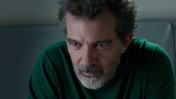 Movie still from “Pain and Glory” (2019), directed by Pedro Almodóvar – A person wearing a green shirt; Close Up shot, Over the shoulder angle