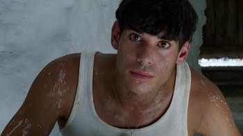 Movie still from “Pain and Glory” (2019), directed by Pedro Almodóvar – A person wearing a tank top; Close Up shot, High angle