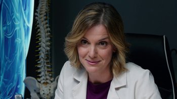 Movie still from “Pain and Glory” (2019), directed by Pedro Almodóvar – A woman sitting in front of a wall with a spine in the background; Close Up shot, Low angle