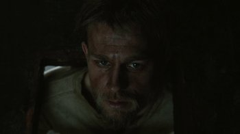 Movie still from “Papillon” (2017), directed by Michael Noer – A person with a beard; Close Up shot, Over the shoulder angle