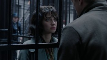 Movie still from “Papillon” (2017), directed by Michael Noer – A woman standing in front of a man behind bars; Close Up shot, Over the shoulder angle