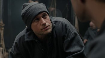 Movie still from “Papillon” (2017), directed by Michael Noer – A person wearing a hat; Close Up shot, Over the shoulder angle