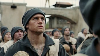 Movie still from “Papillon” (2017), directed by Michael Noer – A group of men standing next to each other; Close Up shot, Low angle