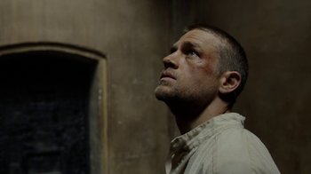Movie still from “Papillon” (2017), directed by Michael Noer – A person looking up at something; Close Up shot, Low angle