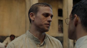 Movie still from “Papillon” (2017), directed by Michael Noer – A person wearing a shirt; Close Up shot, Over the shoulder angle