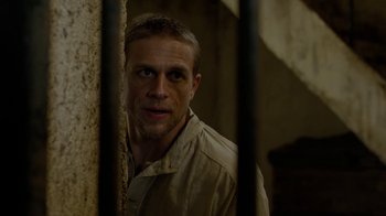 Movie still from “Papillon” (2017), directed by Michael Noer – A person standing in front of a wall; Close Up shot, Over the shoulder angle