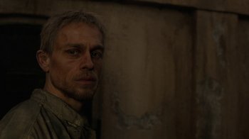 Movie still from “Papillon” (2017), directed by Michael Noer – A person in a room; Close Up shot, High angle