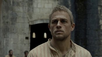Movie still from “Papillon” (2017), directed by Michael Noer – A person wearing a shirt; Close Up shot, Over the shoulder angle