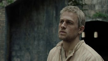 Movie still from “Papillon” (2017), directed by Michael Noer – A person wearing a shirt; Close Up shot, Low angle
