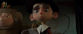 Movie still from “ParaNorman” (2012), directed by Sam Fell – A cartoon character's face with a book; Close Up shot, Low angle