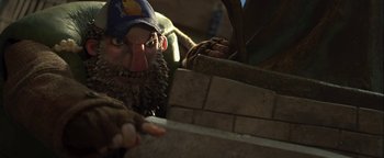 Movie still from “ParaNorman” (2012), directed by Sam Fell – A man with a long beard and a hat is building a brick wall; Close Up shot, Low angle