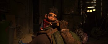 Movie still from “ParaNorman” (2012), directed by Sam Fell – A boy is sitting on a pile of blankets; Medium shot, High angle