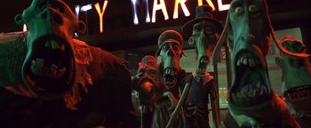 Movie still from “ParaNorman” (2012), directed by Sam Fell – A group of creepy statues in front of a city market sign; Medium shot, Low angle