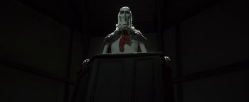 Movie still from “ParaNorman” (2012), directed by Sam Fell – A statue of a man in a suit and tie; Medium shot, Low angle