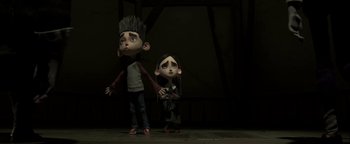 Movie still from “ParaNorman” (2012), directed by Sam Fell – A couple of people standing next to each other on the ground; Medium shot, Low angle