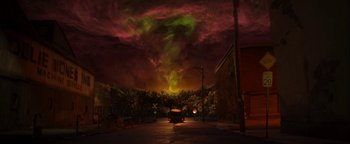 Movie still from “ParaNorman” (2012), directed by Sam Fell – A car driving down a street under a cloudy sky; Extreme Wide shot, High angle