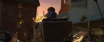 Movie still from “ParaNorman” (2012), directed by Sam Fell – A person sitting on top of a wooden box on top of a building; Wide shot, Low angle