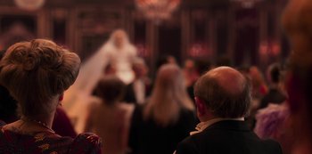 Movie still from “Paradise Hills” (2019), directed by Alice Waddington – A group of people standing in front of a mirror; Medium shot, Over the shoulder angle