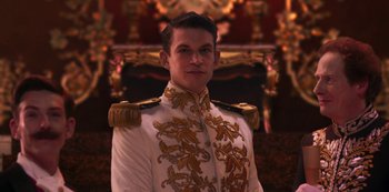 Movie still from “Paradise Hills” (2019), directed by Alice Waddington – A man in a white and gold uniform; Medium shot, Low angle