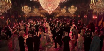 Movie still from “Paradise Hills” (2019), directed by Alice Waddington – A group of people in formal wear dancing in a ballroom; Extreme Wide shot, High angle