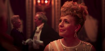 Movie still from “Paradise Hills” (2019), directed by Alice Waddington – A woman in a pink dress and a man in a black suit; Close Up shot, Over the shoulder angle