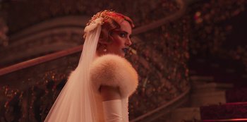 Movie still from “Paradise Hills” (2019), directed by Alice Waddington – A woman with red hair wearing a wedding dress; Close Up shot, Over the shoulder angle