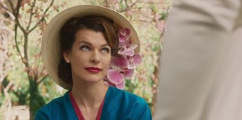 Movie still from “Paradise Hills” (2019), directed by Alice Waddington – A woman wearing a straw hat with flowers in her hair; Close Up shot, Low angle
