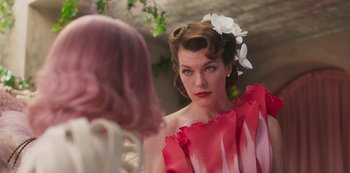Movie still from “Paradise Hills” (2019), directed by Alice Waddington – A woman in a red dress looking at another woman in a pink dress; Close Up shot, Over the shoulder angle