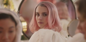 Movie still from “Paradise Hills” (2019), directed by Alice Waddington – A person with pink hair; Close Up shot, Over the shoulder angle