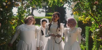Movie still from “Paradise Hills” (2019), directed by Alice Waddington – A group of young people dressed up in white dresses; Medium shot, Over the shoulder angle