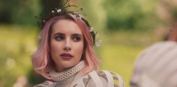Movie still from “Paradise Hills” (2019), directed by Alice Waddington – A woman with pink hair and a flower crown on her head; Close Up shot, Over the shoulder angle