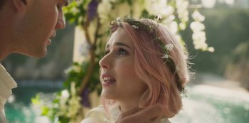 Movie still from “Paradise Hills” (2019), directed by Alice Waddington – A woman with pink hair wearing a flower crown; Close Up shot, Over the shoulder angle