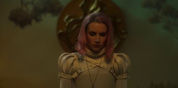 Movie still from “Paradise Hills” (2019), directed by Alice Waddington – A woman with pink hair standing in front of a clock; Close Up shot, Over the shoulder angle