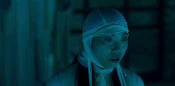 Movie still from “Paradise Hills” (2019), directed by Alice Waddington – A woman with a bandage on her head; Close Up shot, Low angle