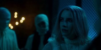 Movie still from “Paradise Hills” (2019), directed by Alice Waddington – A woman standing next to a man in a mask; Close Up shot, Over the shoulder angle