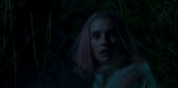 Movie still from “Paradise Hills” (2019), directed by Alice Waddington – A woman with pink hair standing next to a bush; Close Up shot, Low angle