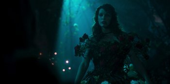 Movie still from “Paradise Hills” (2019), directed by Alice Waddington – A woman wearing a dress with roses on it; Medium shot, Over the shoulder angle