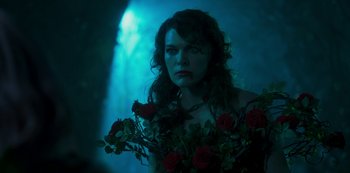 Movie still from “Paradise Hills” (2019), directed by Alice Waddington – A beautiful woman holding a bouquet of roses; Close Up shot, Over the shoulder angle