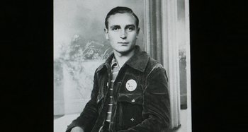 Movie still from “Parallel Mothers” (2021), directed by Pedro Almodóvar – An old photo of a young man wearing a jacket; Close Up shot, High angle